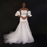 3D Hand embellished organza floral bustier gown with removable puff sleeves.