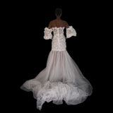 3D Hand embellished organza floral bustier gown with removable puff sleeves.