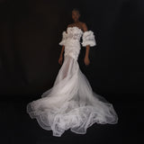 3D Hand embellished organza floral bustier gown with removable puff sleeves.