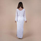 Odessa Tulle Sequin Long Sleeve Top versatile layer to strapless dresses or even as a top. Handcrafted with intricate sequin embellishments to wow at any special occasion event. Versatile styling for casual or formal wear, perfect for brides and monochromatic looks. Possible as a modest layer over a wedding dress. Featuring the back of the top..
