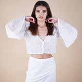 Odessa Tulle Sequin Long Sleeve Top versatile layer to strapless dresses or even as a top. Handcrafted with intricate sequin embellishments to wow at any special occasion event. Versatile styling for casual or formal wear, perfect for brides and monochromatic looks. Possible as a modest layer over a wedding dress. Close up showing the sleeves.