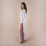 Giselle Off-White Sequin Maxi Long Skirt. Perfect for a boho look, nights out, weddings, brides, white parties and spring transitions. Handcrafted with intricate sequin embellishments, this skirt adds glamour to any occasion. Indulge midi skirts, high waisted skirt, skirt with a slit, long skirt.Styled with the Odessa top.