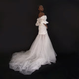 3D Hand embellished organza floral bustier gown with removable puff sleeves.