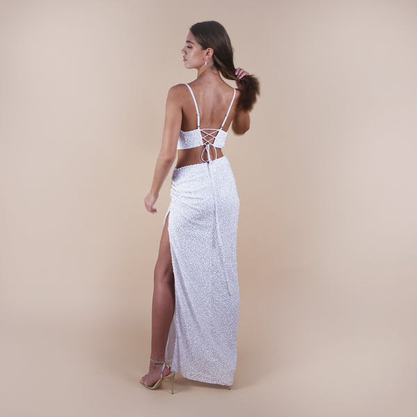 Giselle Off-White Sequin Maxi Long Skirt. Perfect for a boho look, nights out, weddings, brides, white parties and spring transitions. Handcrafted with intricate sequin embellishments, this skirt adds glamour to any occasion. Indulge midi skirts, high waisted skirt, skirt with a slit, long skirt. With Anastasia Bra Crop Top